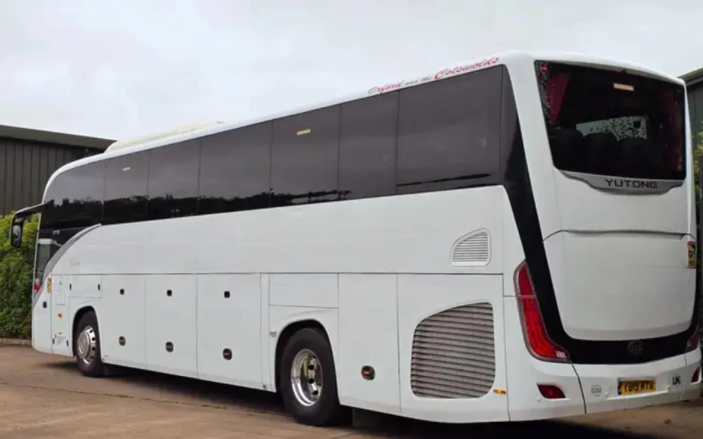 The rear exterior of the YUTONG T122HDH coach, showcasing its sleek white design with tinted windows and modern styling.